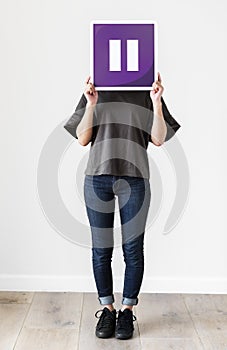 Girl holding a purple pause icon photo