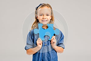 Girl holding a puzzle