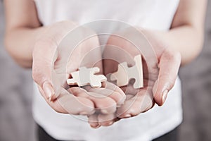 Girl holding a puzzle in her hand