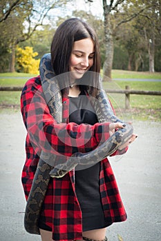 Girl holding python snake