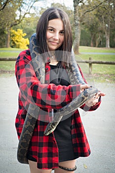 Girl holding python snake