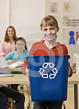 Girl holding recycling bin