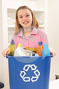 Girl Holding Recyling Waste Bin At Home