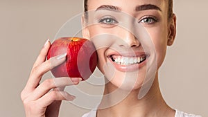 Girl Holding Red Apple Near Face Smiling, Studio Shot, Panorama