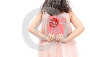 Girl holding a red gift behind her back isolated