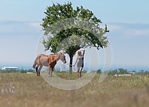 Girl holding reins of horse photo