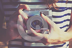 Girl holding retro camera