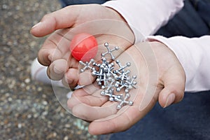 Girl Holding Rubber Ball And Jacks