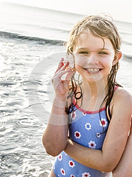 Girl holding a shell to her ear