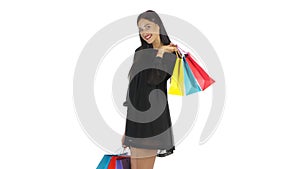 Girl holding shopping bags and laughing and smiling. White