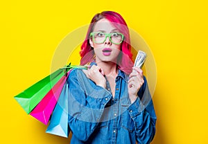 Girl holding shopping bags with money