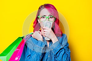 Girl holding shopping bags with money