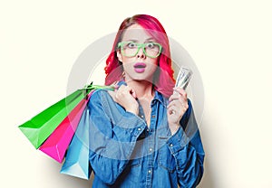 Girl holding shopping bags with money