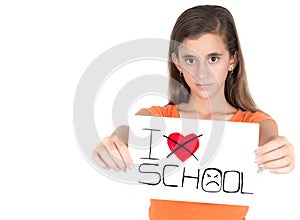 Girl holding a sign with the words I hate school