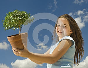 Girl holding small tree