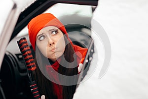 Girl Holding Snow Brush Scraper Ready to Clean the Car