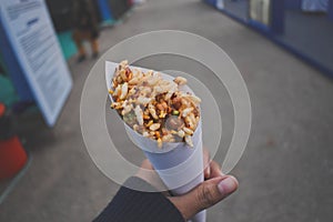 Girl holding spicy bhelpuri