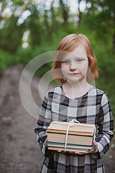 Girl holding a stack of book