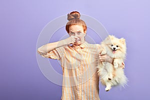 Girl holding stinky stray dog photo