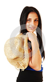 Girl holding straw hat.