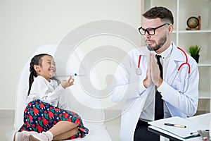 girl holding a syringe needle with injection vaccination to doctor. is afraid. doctor in fear of injection.Trypanophobia doctor photo