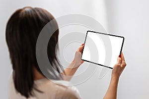 Girl holding tablet with isolated screen for mockup. Moder tablet with thin edges