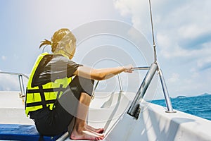 Girl holding tight the rope when riding on speed boat