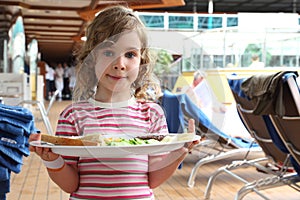 Girl holding tray with food on cruise liner