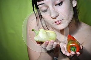 Girl holding two peppers