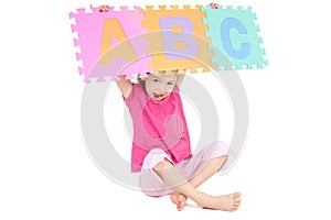 Girl holding up alphabet abc sign