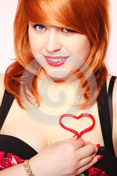 Girl holding valentine red heart love symbol. Valentines day.