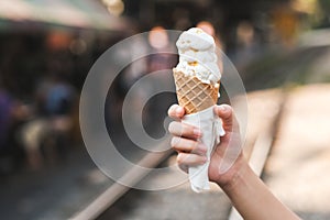 Girl holding a vanilla ice cream cone