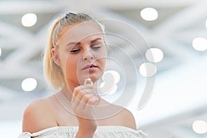 A girl holding a wedding ring doubtfully