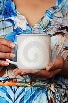 Girl holding white coffee mug mockup. Blank white cup mock up for your company logo and design