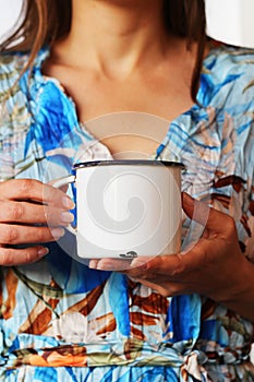 Girl holding white coffee mug mockup. Blank white cup mock up for your company logo and design