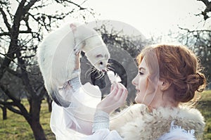 Girl holding a white ferret