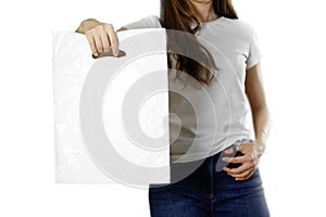 Girl holding a white plastic bag. Close up. Isolated background