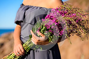 Girl holding a willow-herb bouquet