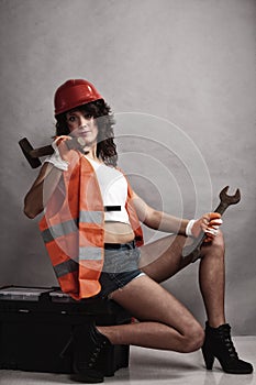 girl holding wrench spanner and hammer