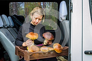 Girl holds big white mushrooms in her hands