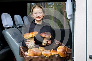 Girl holds big white mushrooms in her hands