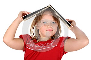 Girl holds a book on her head isolated on white