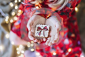 A girl holds Christmas gingerbread in her hands