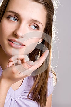 A girl holds a contact lens