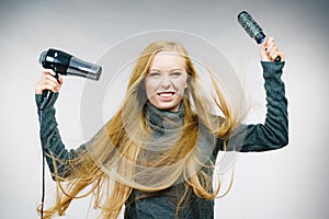 Girl holds hair accessories, styling hair