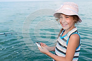 girl holds in hands freshly caught photo