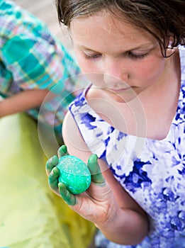 Girl Holds Her Dyed Green Easter Egg