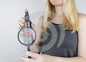 Girl holds in her hands three eco-friendly antiperspirants with natural ingredients. Refusal of antiperspirants containing toxic