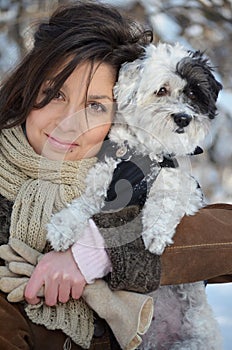 Girl holds her little dressed dog