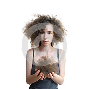 Girl holds her lost hair in her hands and looks disappointed. Fluffy hair after removing dreadlocks. Healthy concept. Girl show